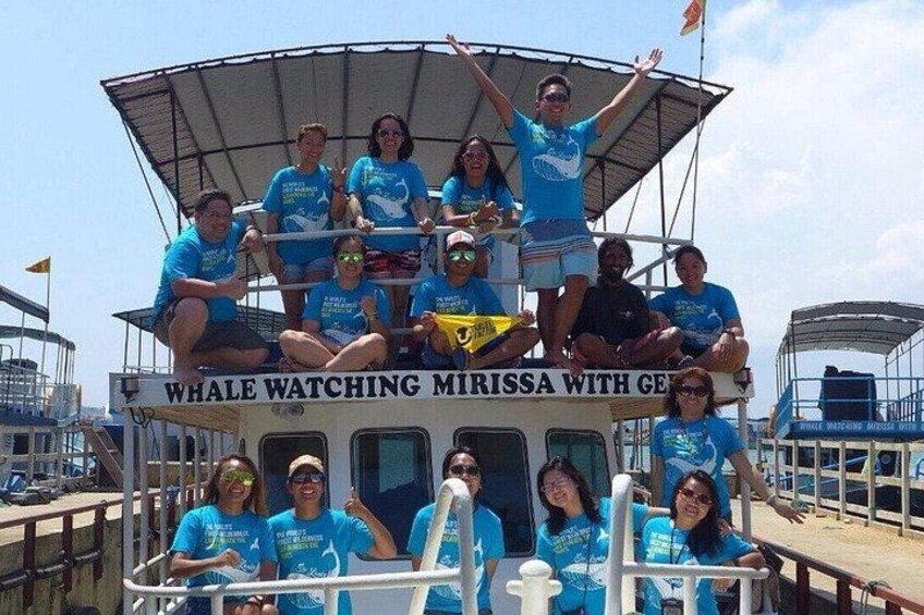 A group of people on a boat with a canopy, labeled 'Whale Watching Mirissa with GE.' 5