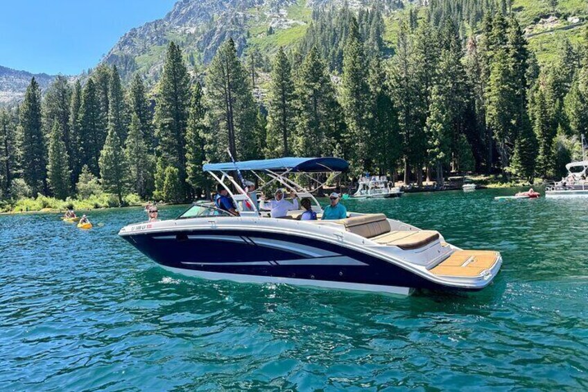 A motorboat on a lake with a forested mountain backdrop. 2