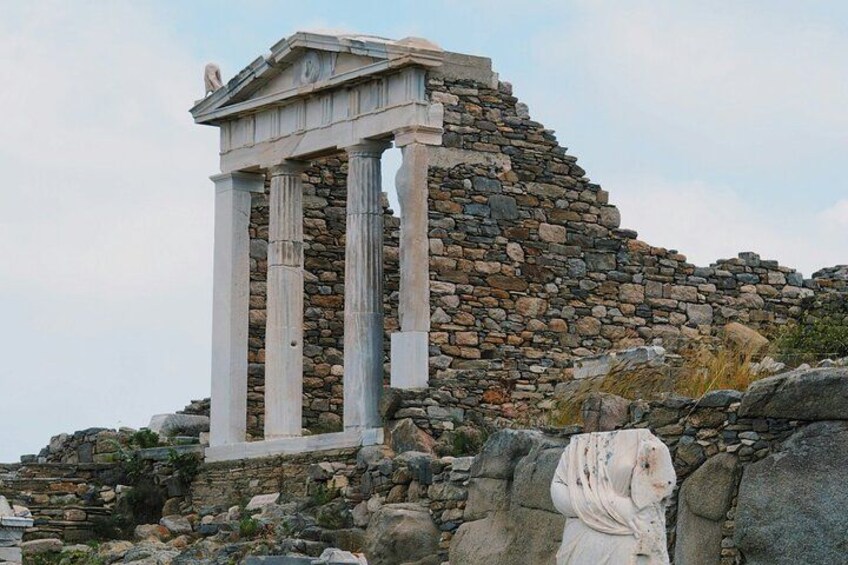 Ancient ruins with columns and a stone wall. 2