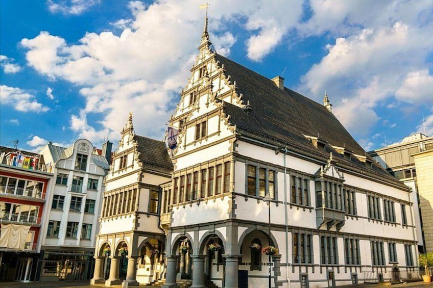 A historic building with ornate architecture, including a steeply pitched roof and decorative elements. 4