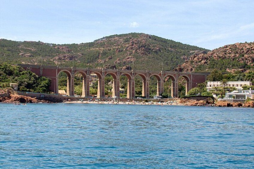 A bridge over water with a mountainous backdrop. 5