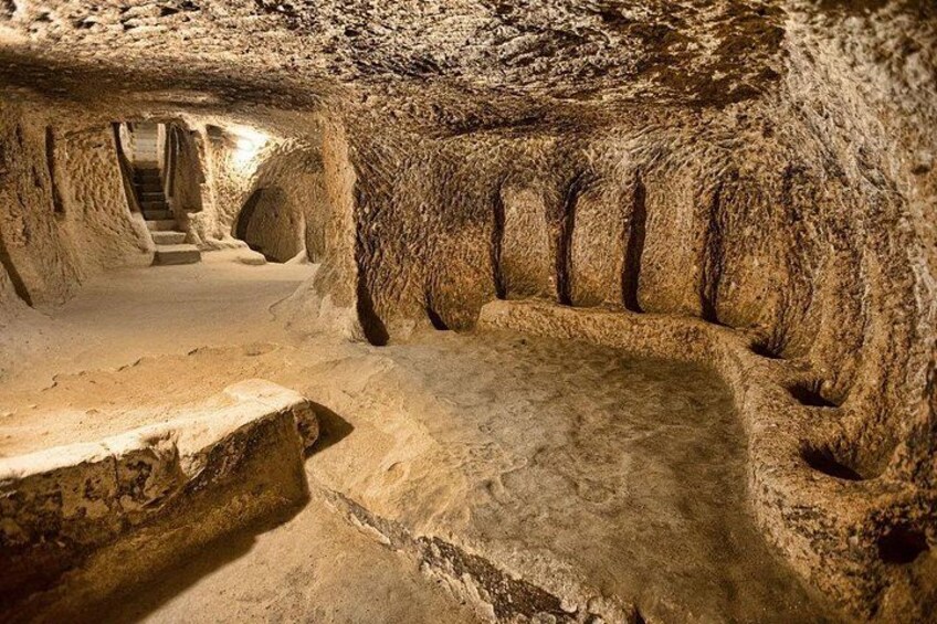 An underground cave with a staircase leading to a higher level. 3