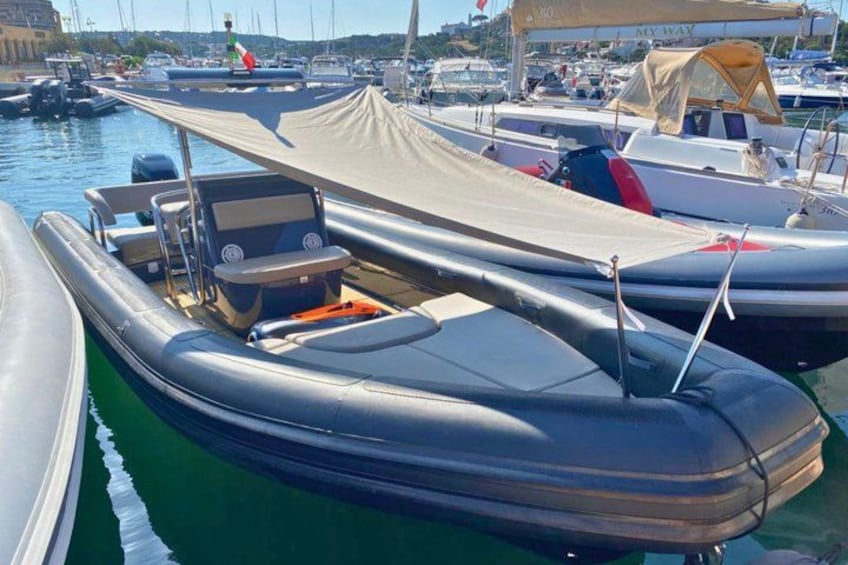 A row of boats docked at a marina with a clear sky. 3