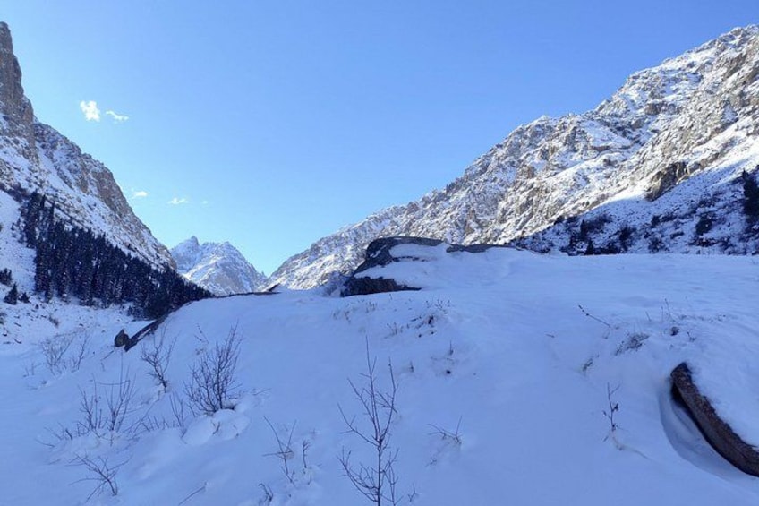 A snow-covered mountainous landscape with a clear sky. 5