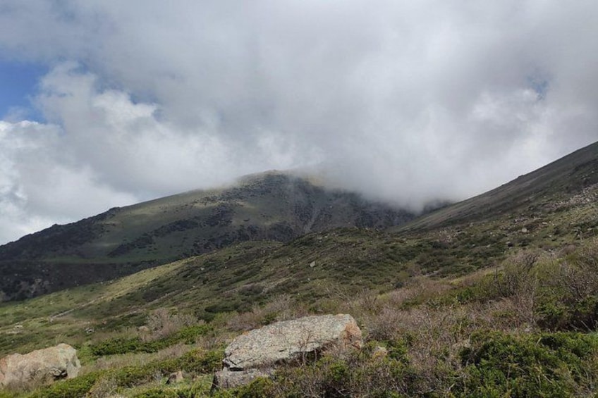 A mountainous landscape with rocky terrain and sparse vegetation. 2