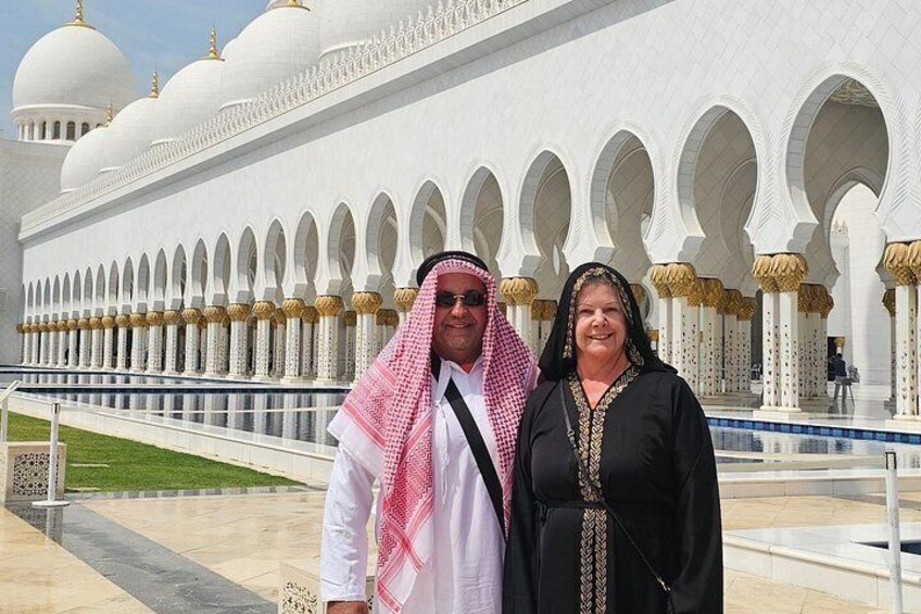 A large white building with multiple domes and arches. 4