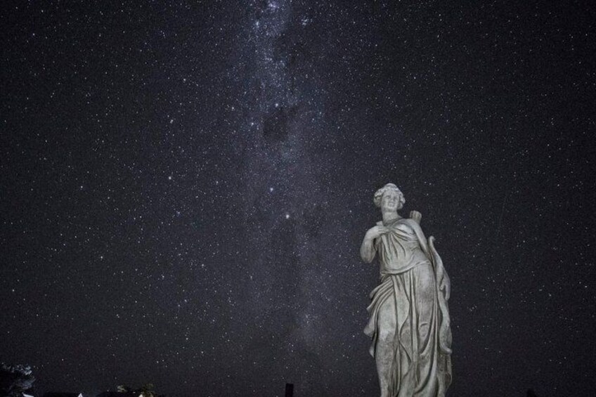 A statue against a starry night sky. 3