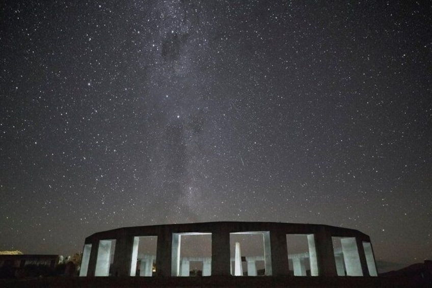 A circular building with multiple windows under a starry night sky. 2