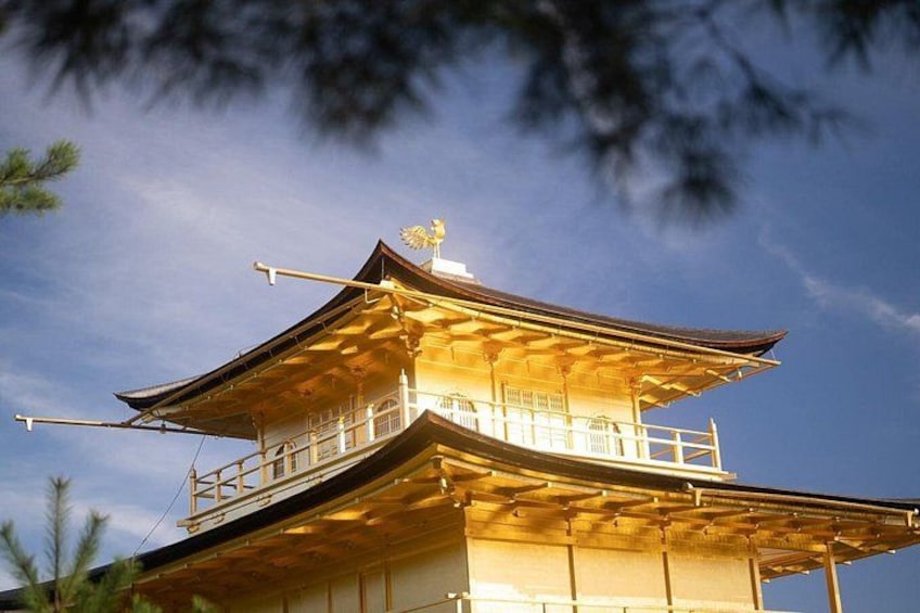 A traditional multi-tiered pagoda with a golden roof, surrounded by trees. 5