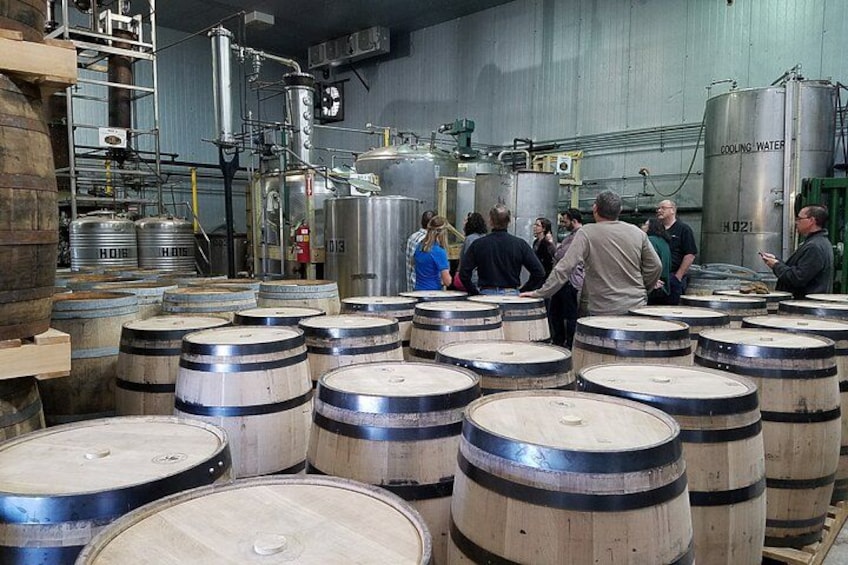 Große Holzböden in einem Lagerhaus, umgeben von Industrieausrüstung und Metalltanks. 1