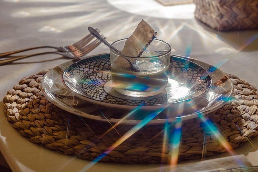 A woven mat with a glass bowl and a spoon on top, placed on a table. 3