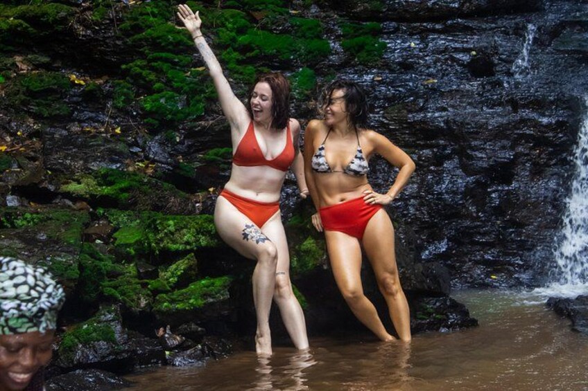 Two people in swimsuits near a waterfall. 5