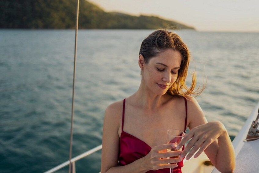 A person on a boat with a body of water and a distant shoreline in the background. 4