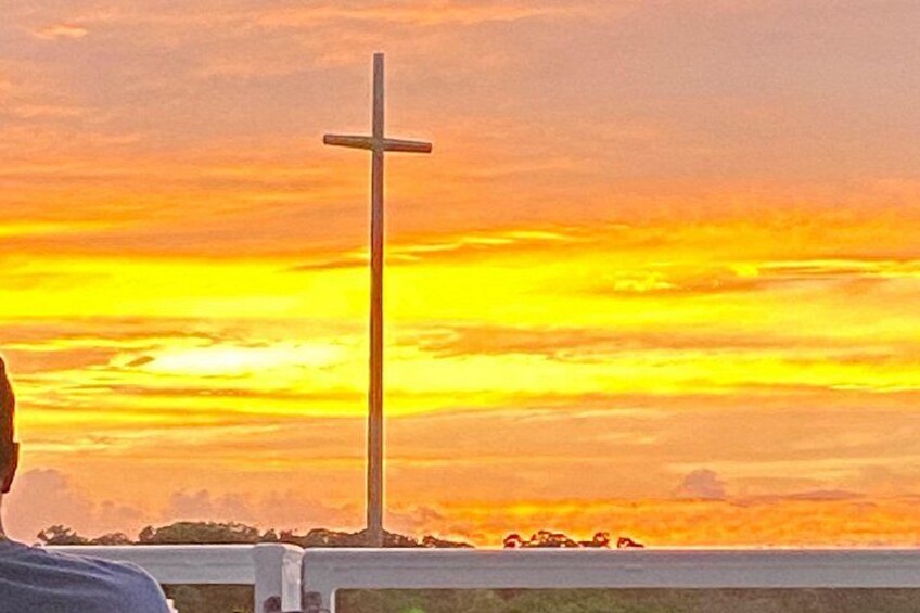 A cross against a sunset sky. 5