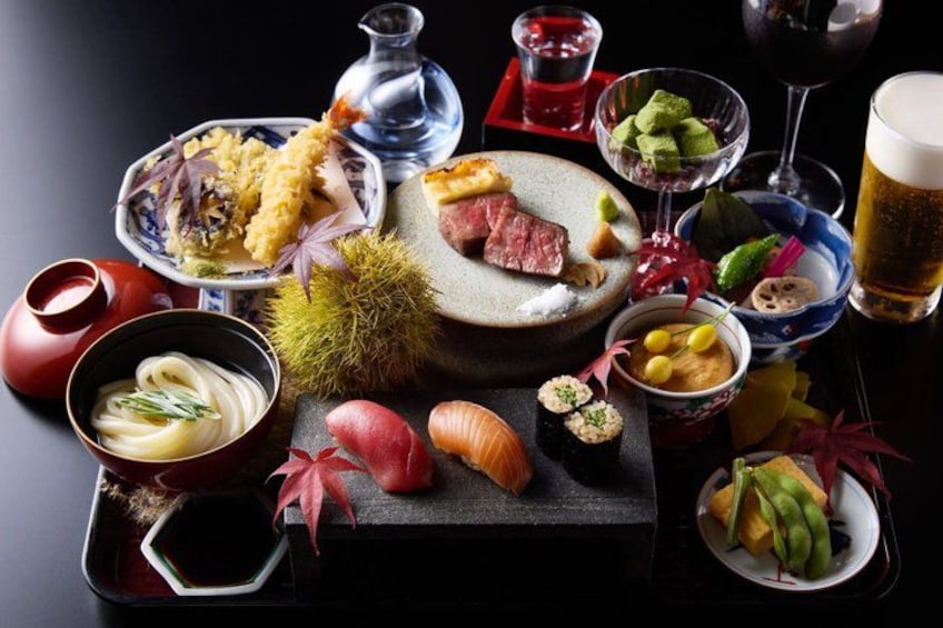 A variety of Japanese dishes, including sushi, sashimi, and a bowl of noodles, arranged on a table. 3
