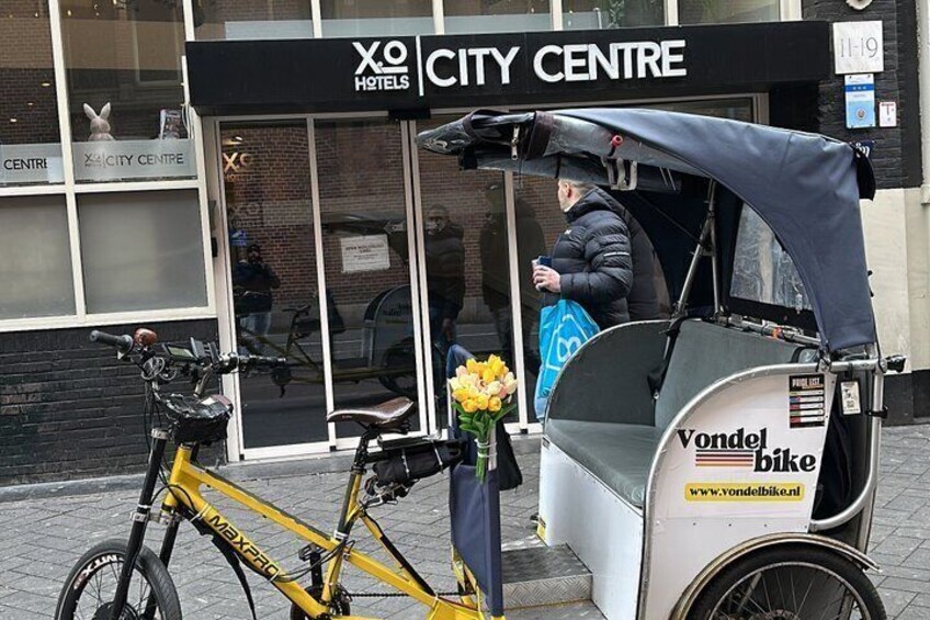 A yellow bicycle parked in front of a building with a sign that reads 'CITY CENTRE.' 3