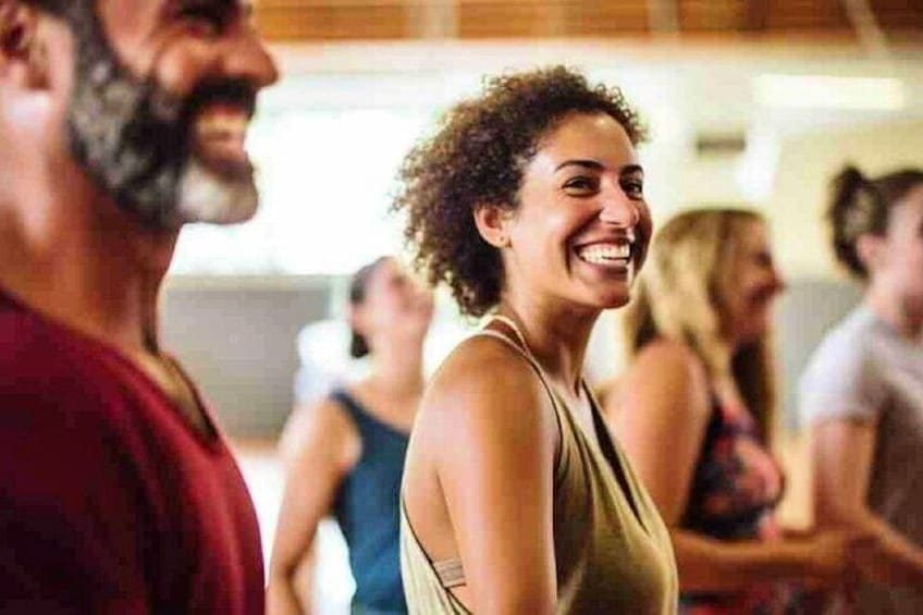 A group of people in a gym, some wearing workout attire. 3