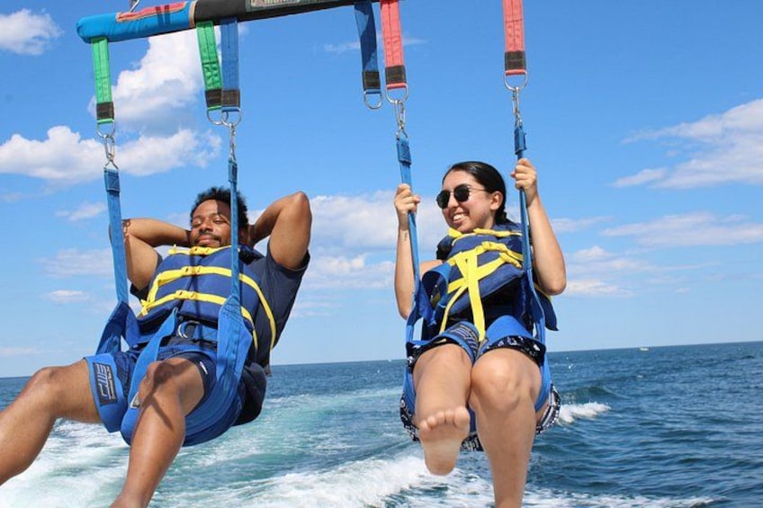 Two people on a water sport activity, wearing life jackets and harnesses. 3