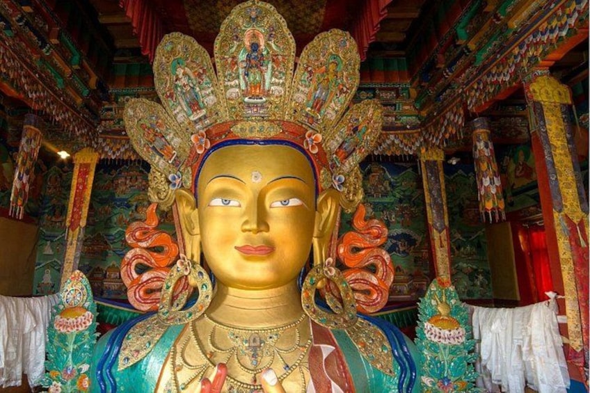 A large, ornate statue with intricate decorations and a colorful headdress. 4