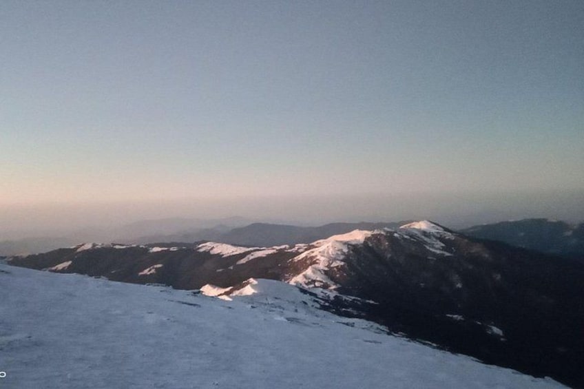 A snow-covered mountain range with a clear sky. 4