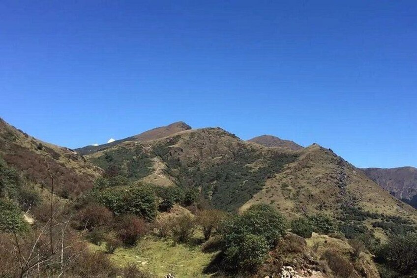 A mountainous landscape with a clear sky. 1