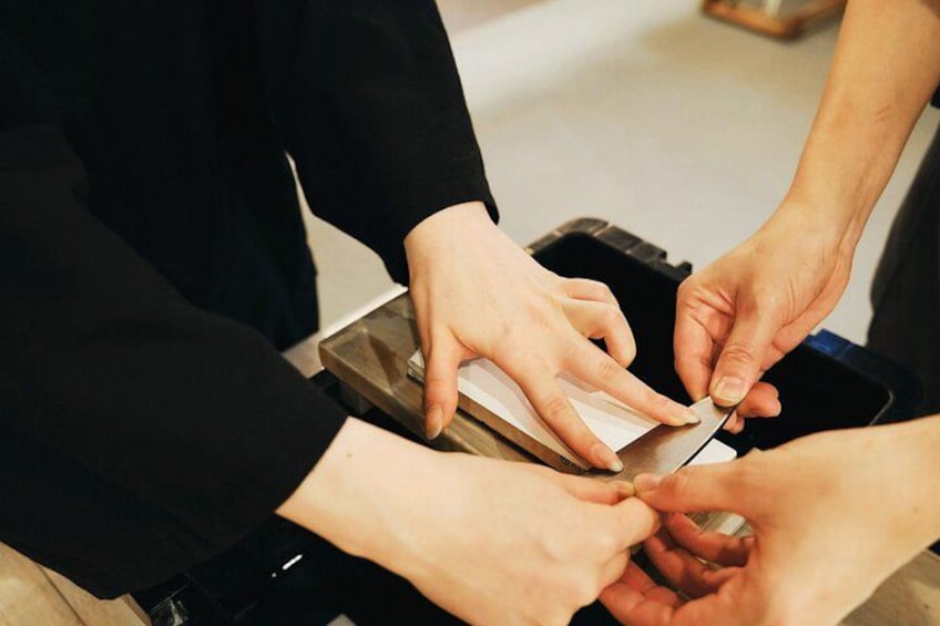 Hands performing a task with a tool, possibly related to food preparation or repair. 5