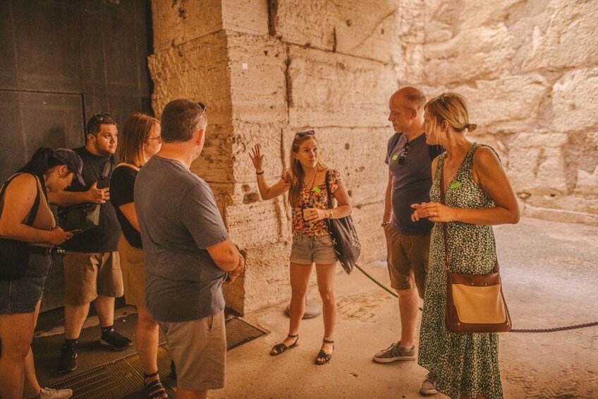 A group of tourists in an ancient stone building. 4