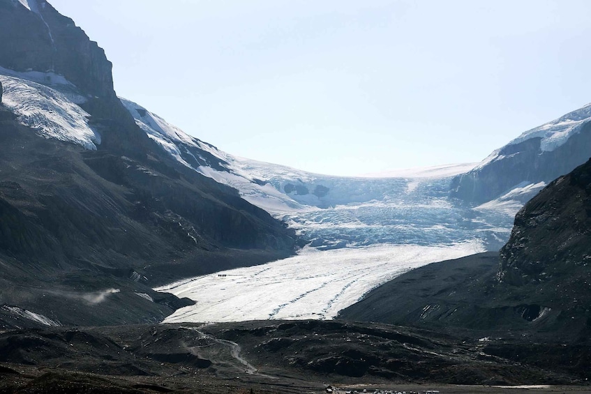 A glacier valley with steep cliffs and a snow-covered glacier. 5