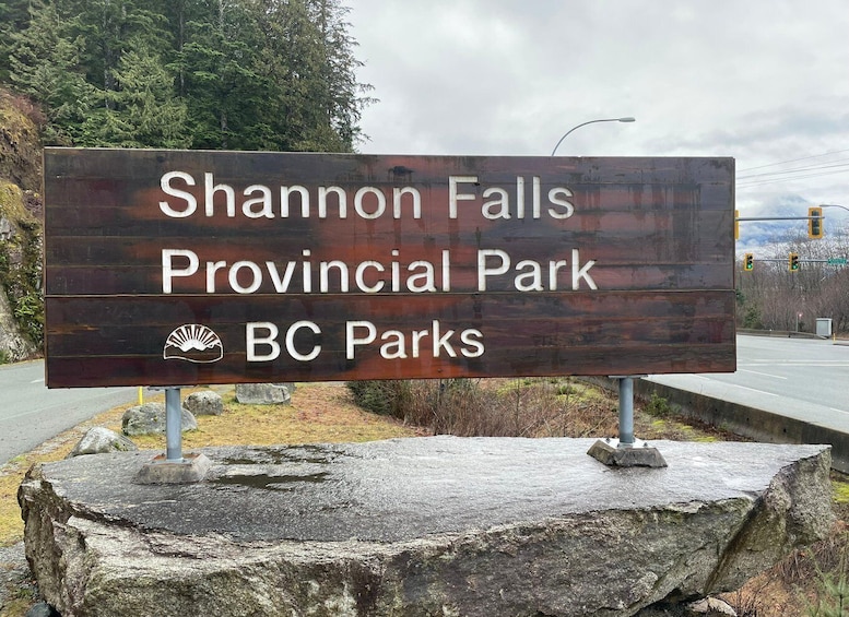 A sign for Shannon Falls Provincial Park with a mountain and sun logo. 3