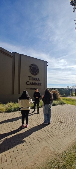 A paved pathway leading to a building with a sign reading 'TERRA CAMIARE.' 3