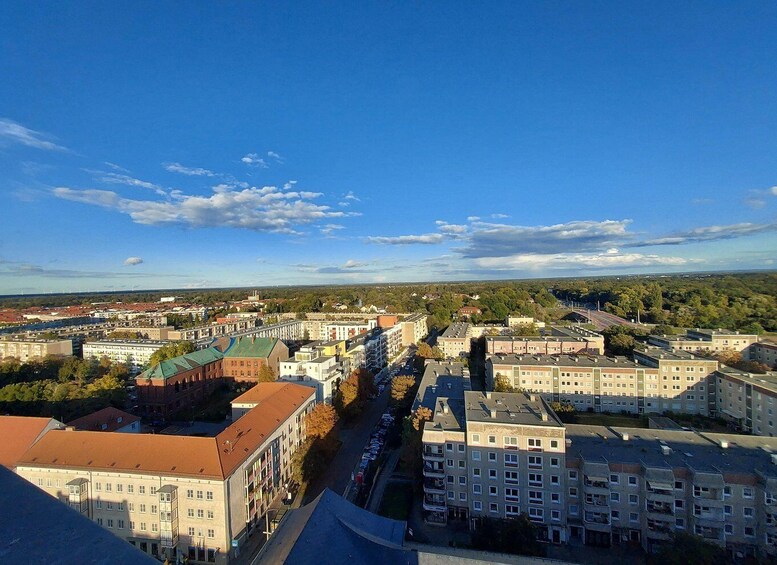 A cityscape with multiple buildings, roads, and a clear blue sky. 5