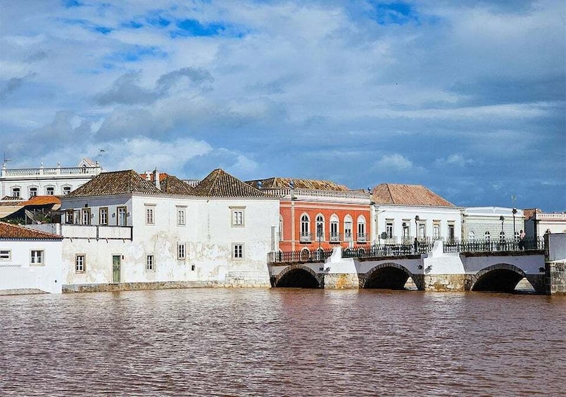 A historic bridge over a river with buildings on either side. 1