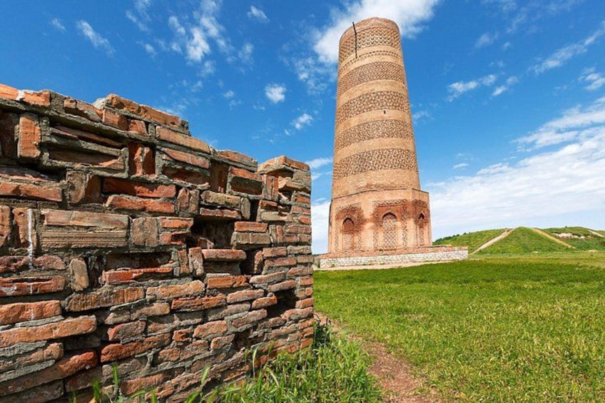 A brick wall and a tall, cylindrical tower with a spiral staircase. 4