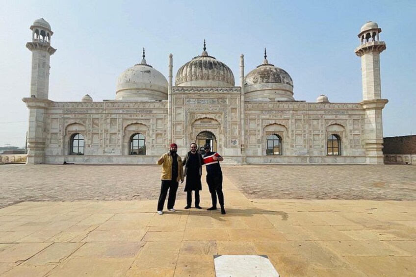 A large, white marble building with domes and minarets. 4