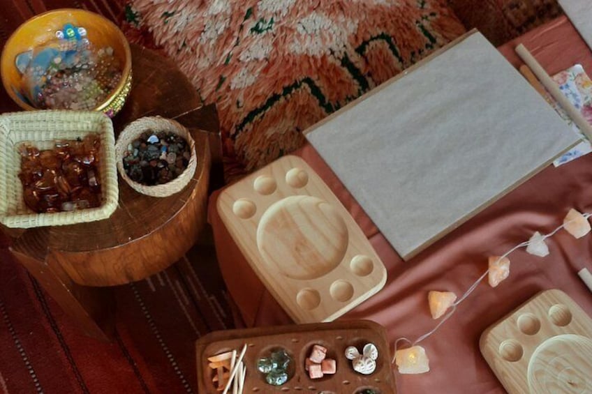 A wooden tray with stones, a bowl of beads, and a wooden box with a lid. 2
