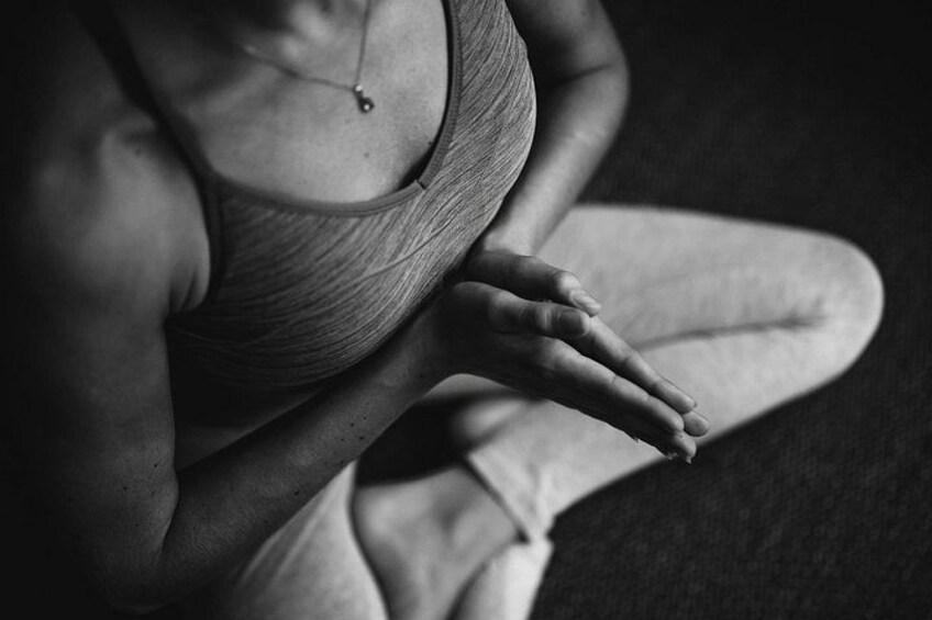 A person sitting with their hands resting on their knees. 2