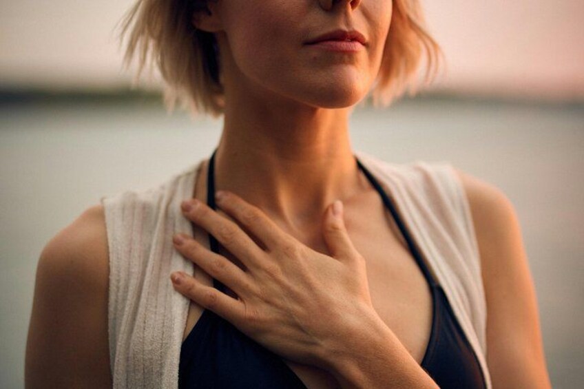 A person wearing a sleeveless top and a light-colored shawl. 2