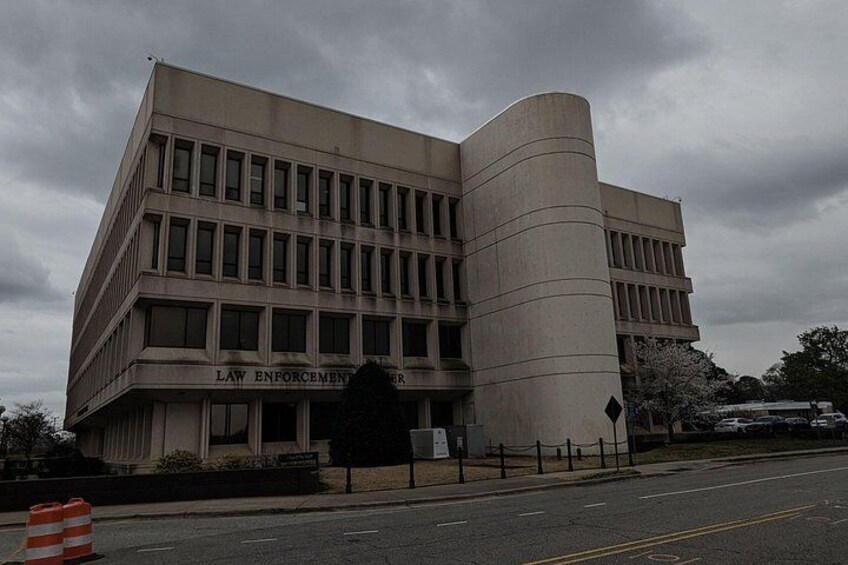 A law enforcement building with a curved facade and a sign reading 'LAW ENFORCEMENT'. 1