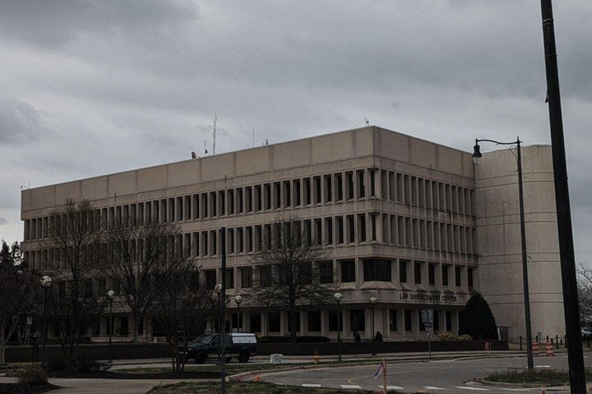 A large, multi-story building with a flat roof and a symmetrical facade. 2