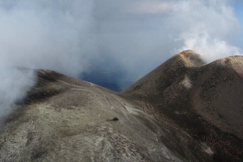 A mountainous landscape with clouds partially obscuring the peaks. 5