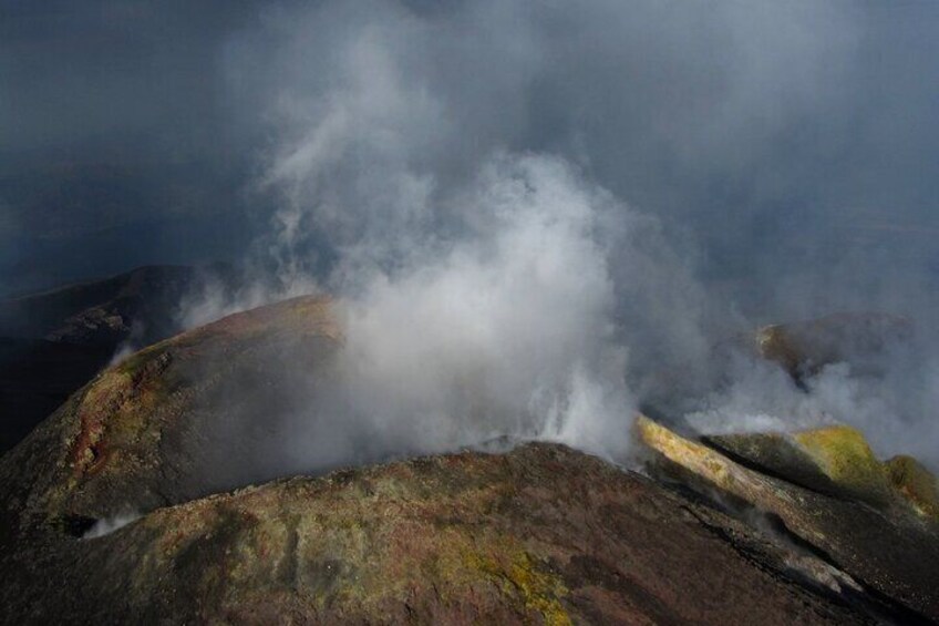 A steam venting from a rocky surface, surrounded by mist and rugged terrain. 3