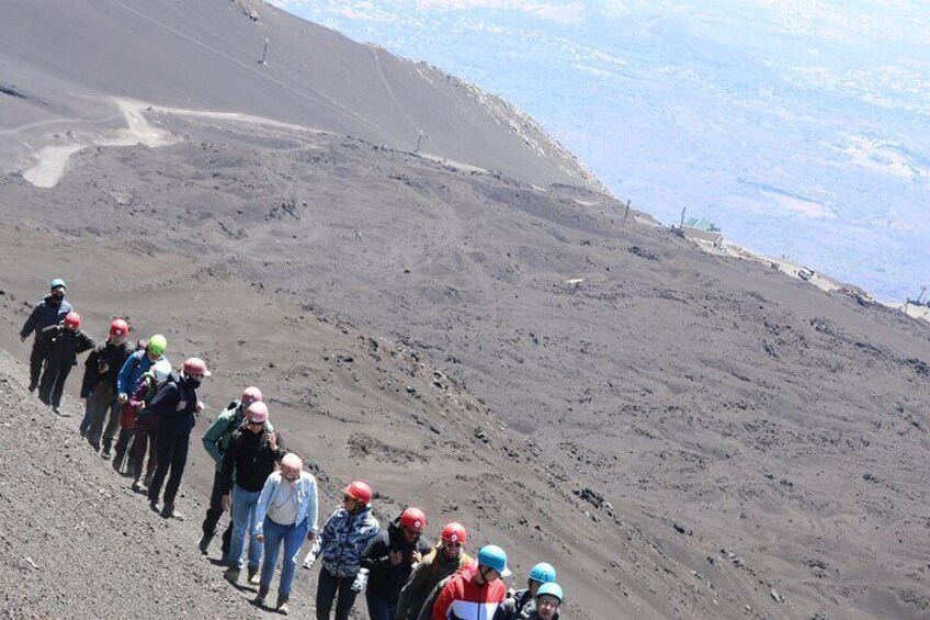 A group of people hiking on a rocky slope. 1