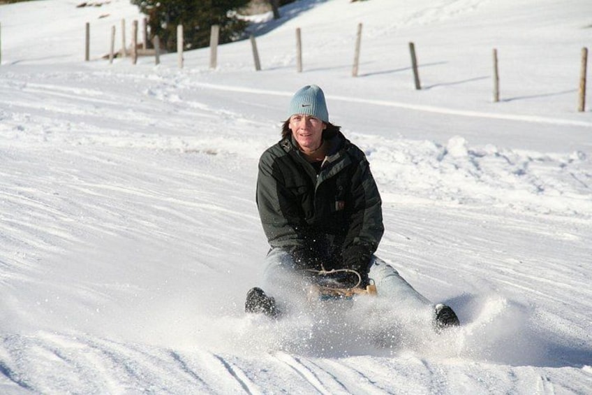 A person sledding down a snowy slope. 1