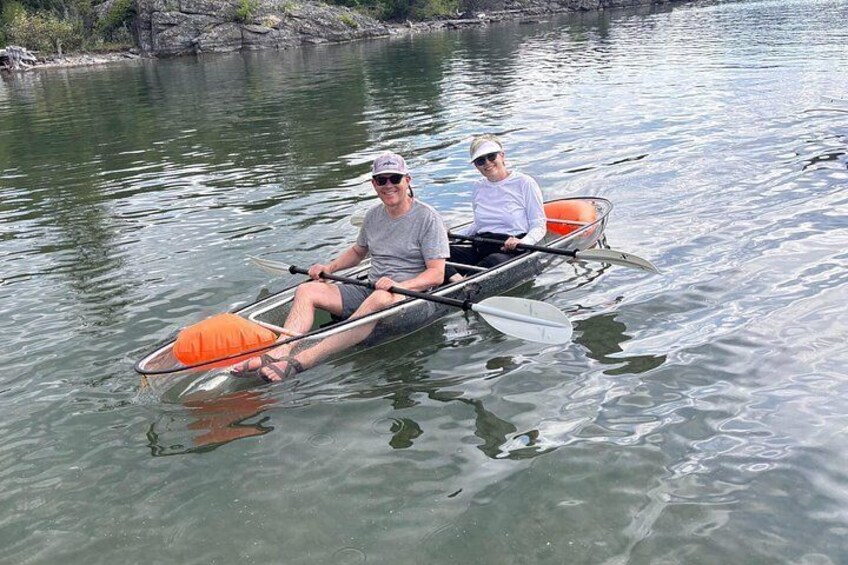 Two people in a narrow boat on a calm river. 2
