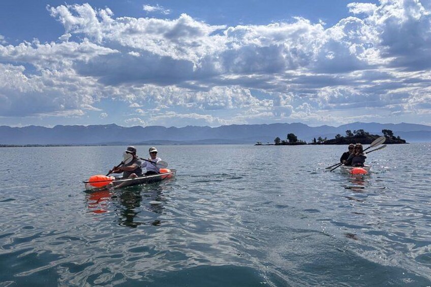 Two kayaks on a calm lake with mountains in the background. 5