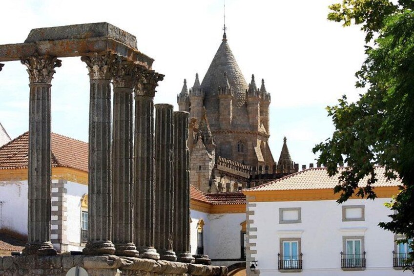 Ancient columns, a castle, and a white building with blue doors. 5