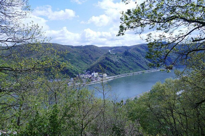 A river, a bridge, and a town surrounded by hills. 5