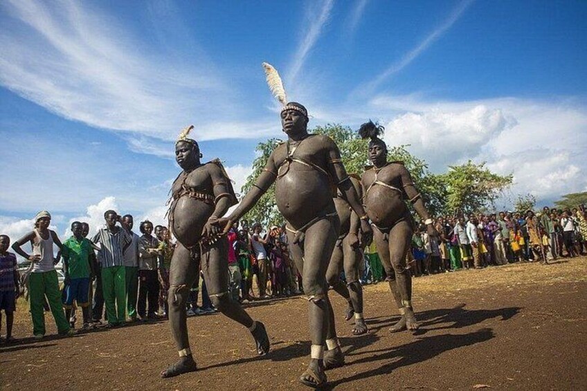 A group of people in traditional attire performing a dance. 2