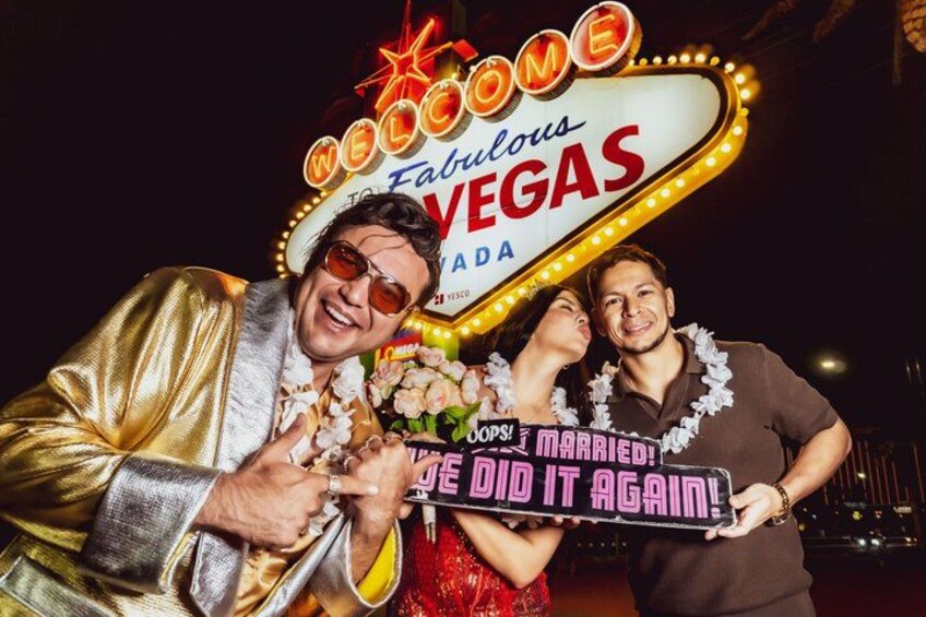 A neon sign with 'Welcome to Fabulous Vegas' and a couple holding a sign that says 'Oops! I did it again!' 2