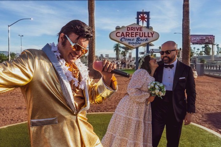 A person in a gold suit holding a microphone, a person in a white dress holding a bouquet, and a person in a black suit. 3